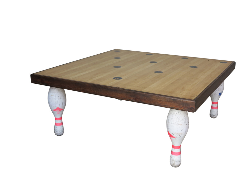 At UKAA we have for sale an original heavy bowling alley table top and skittles legs coffee table. This genuine hard wearing table is easy to wipe clean, the legs can be cut down free of charge to reduce the height. We also have for sale skittles and bowling balls to complete the set