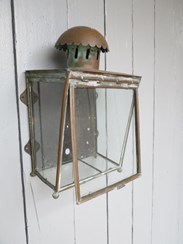 The front pane of glass hinges as per below to allow access to the centre of the lantern