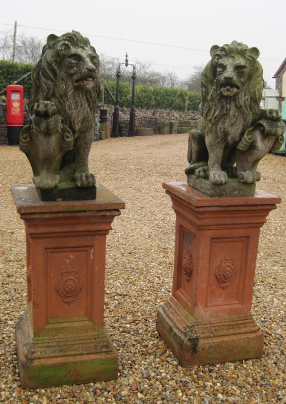 Antique salvaged pair of armorial lion statues on plinths