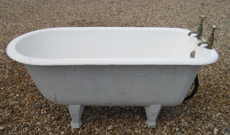 Original Victorian bathrooms freestanding small children's cast iron bath with an enamel roll top suitable for old traditional bathrooms